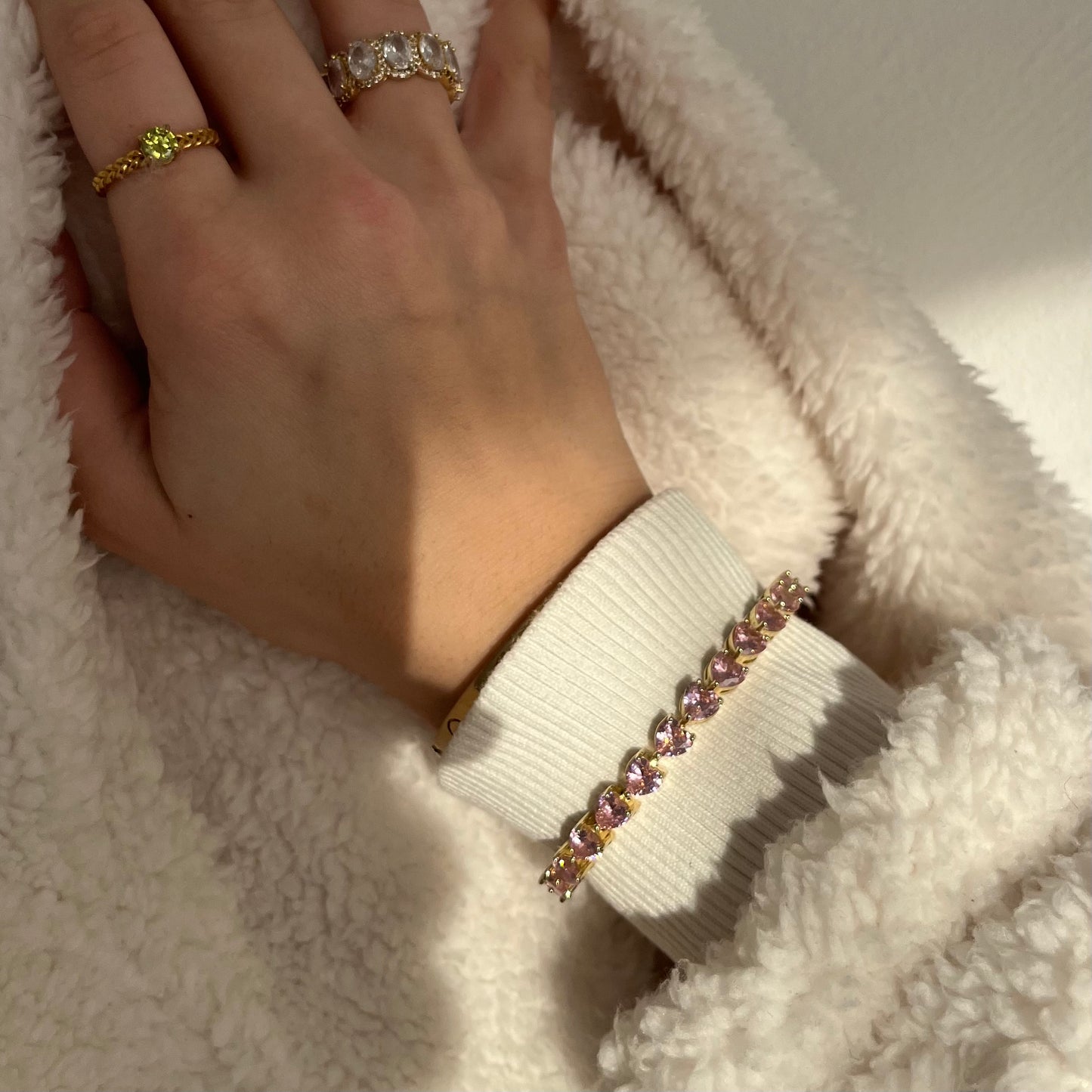Goldenes Tennis Armband mit Rosa Zirkonia Herzen. Eingraviert mit dem Anna Carolina Logo. Das Armband hat Rosa herzen und ist ein Geschenk mit liebe für die Partnerin, Beste Freundin oder kann auch als Freundschaftsarmband getragen werden.