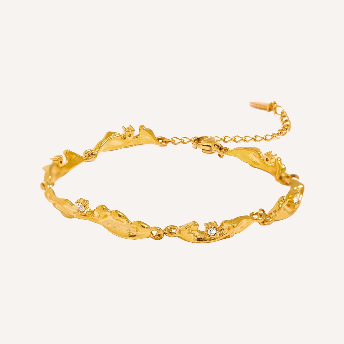 Bracelet shaped with gold pieces that look like waves. Set with zirconia stones.